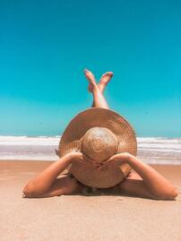 Lady lying on a beach in Spain
